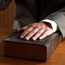Hand on bible